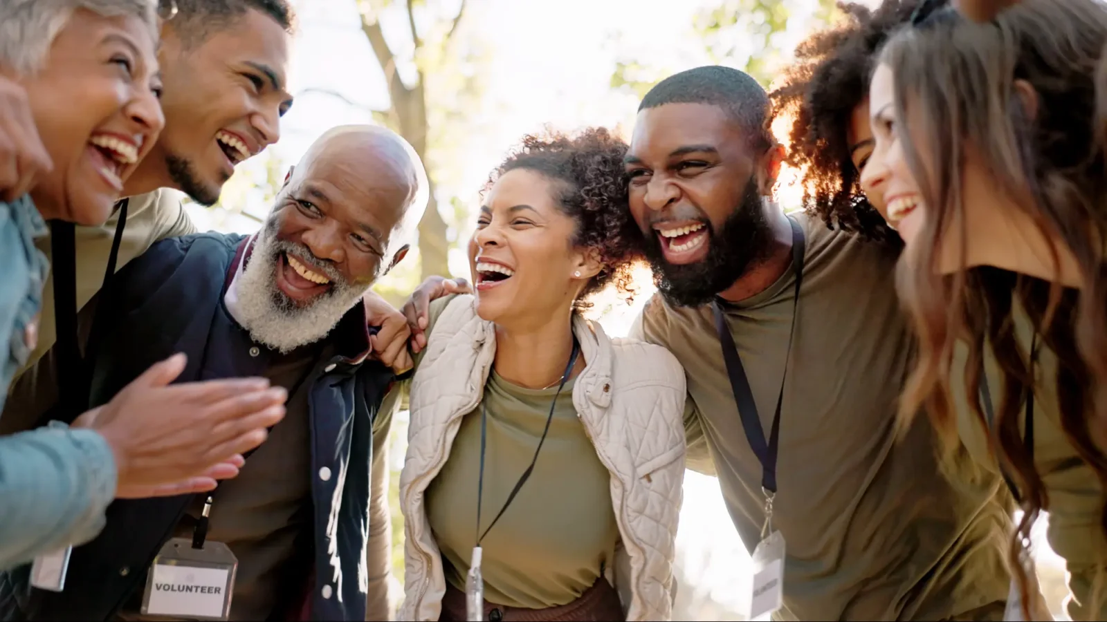 Group of volunteers laughing in a huddle.