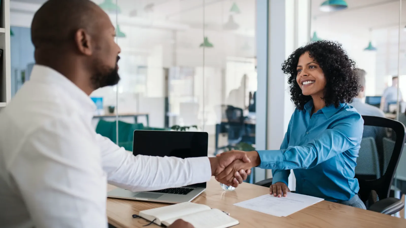 Job applicant shaking the hand of an interviewer.