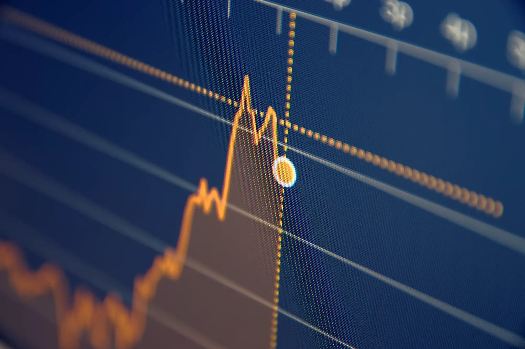 A close-up of a digital line chart on a dark screen showing an overall upward trend highlighted by a yellow data point near a peak.